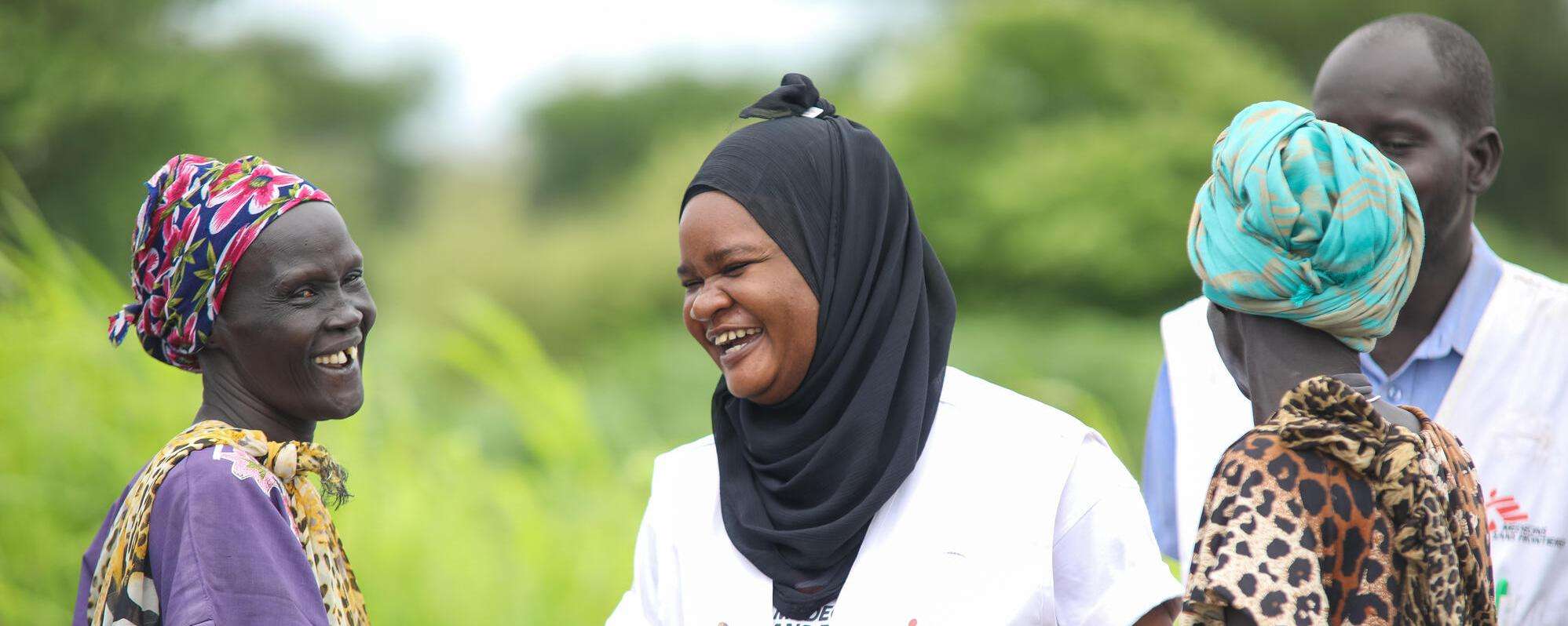 MSF nurse activity manager Awa Abdou smiles while talking to patients in South Sudan