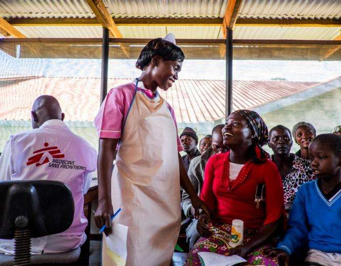 In the HIV department of Arua Regional hospital-Uganda, a patient and MSF staff member smile at one another warmly